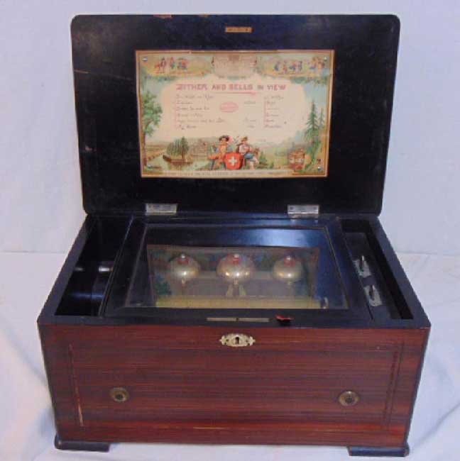 Inlaid music box, zither and bells in view
