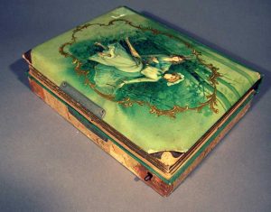 A turn of the century music box with attached photo album